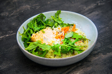 Delicious fillet of cod fish with carrots, leeks and mushrooms in white plate ready to be served
