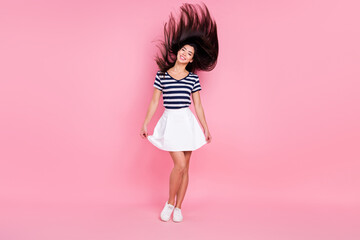 Photo of cute sweet young woman wear striped outfit dancing smiling isolated pink color background