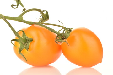 Two appetizing yellow plum tomatoes, close-up, isolated on white.