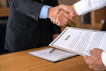 Businessperson Shaking Hand With Candidate, Job applicant having the interview manager shaking hands in a contemporary office. Human resources concept.