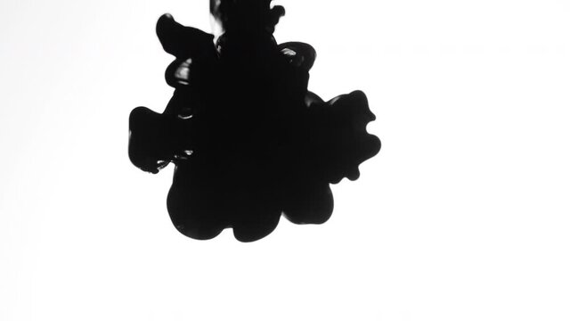 Abstract Shot of Drops of Thick Black Ink in Water on White Background