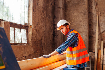 Fototapeta na wymiar The young workers are cutting boards at the wood factory