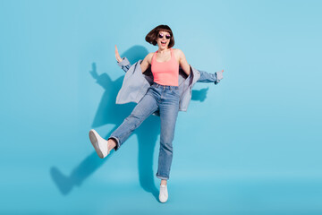 Full body photo of hooray millennial lady dance yell wear pink top jeans eyewear isolated on blue color background
