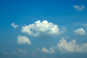 White beautiful clouds on the blue sky on a sunny day