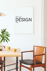 Fototapeta na wymiar Stylish and eclectic dining room interior with mock up poster map, sharing table design chairs, gold pedant lamp and elegant sofa in second space. White walls, wooden parquet. Tropical leafs in vase.