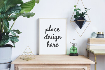Creative composition of stylish home interior design with mock up poster frame, wooden commode, plants in designed pots and accessories. Plants and nature love concept. Template..