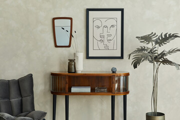 Stylish composition of creative living room interior with mock up poster frame, wooden commode, grey chair, palm, mirror, dry banch in vase and elegant personal accessories. 