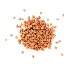 Roasted buckwheat grains, isolated on white background. Dry brown buckwheat groats. Top view.