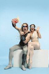 Movie lover. Young couple of ballet dancers in ancient Rome costums at blue studio.