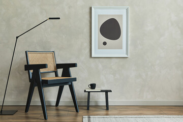 Stylish composition of cozy living room interior with mock up poster frame, wooden armchair, black modern lamp and black tiny coffee table with personal accessories on it. Neutral wall.