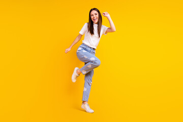 Fototapeta na wymiar Full length photo of young excited girl happy positive smile have fun dance isolated over yellow color background