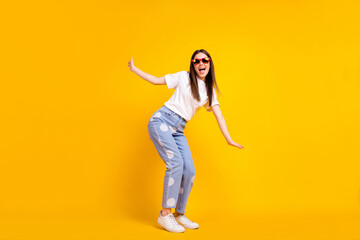 Full body profile side photo of young excited girl happy positive smile playful have fun isolated over yellow color background