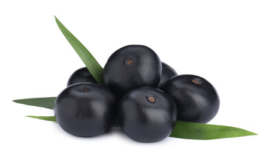 Pile of fresh ripe acai berries and green leaves on white background