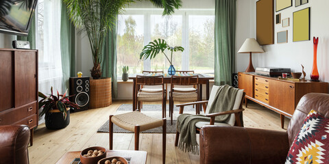 Modern scandinavian home interior of living room with design retro furniture, tropical plant, window, decoration and elegant personal accessoreis in stylish home decor.
