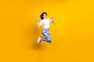 Fototapeta na wymiar Full body profile side photo of young girl happy positive smile show peace cool v-sign isolated over yellow color background