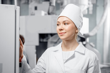 Concept food industry banner. Factory worker inspecting production line tanker in of dairy factory