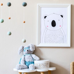 Stylish scandinavian nursery interior with mock up photo frame, plush toy, design furniture, toys and accessories. Beautiful decoration on the beige background wall. Home decor for children room.