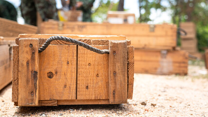 A supply wooden crate box placed on ground. It's using to contain military items such as weapon and explosive material for transportation. Object photo.