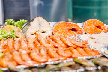 Sea market, fresh trout, cod and tuna meat, boiled red king prawns