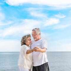 Fototapeta na wymiar Happy asian senior retired couple, relax smiling elder man and woman enjoying with retired vacation at sea beach outdoor. Health care, Family outdoor lifestyle
