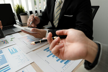 Business casual team are presenting and discussing company growth project success financial statistics, professional investor working start up project for strategy plan with document