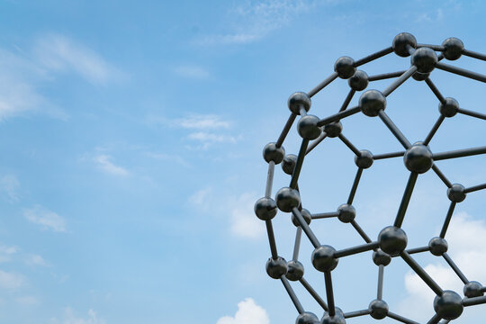 Atom or molecules model. Reflective and refractive abstract molecular shape.science model with blue sky background.	