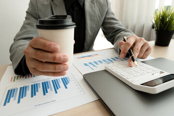 Businessman working in finance and accounting Analyze financial budget in the office.