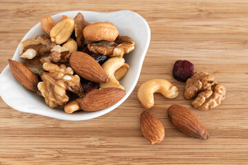 Mix of nuts on wooden background
