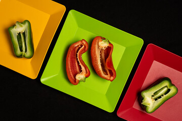 square colored plates with vegetables and fruits