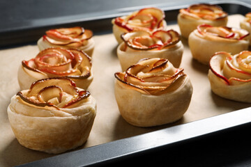 Tray with freshly baked apple roses, closeup view. Beautiful dessert