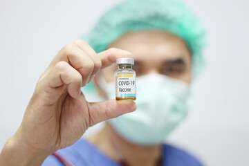 doctor holding covid - 19 coronavirus vaccine