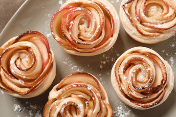 Fototapeta premium Freshly baked apple roses on plate. top view. Beautiful dessert