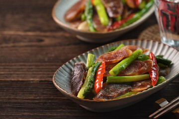 Delicious spicy homemade stir-fried Chinese smoked sausage with asparagus.