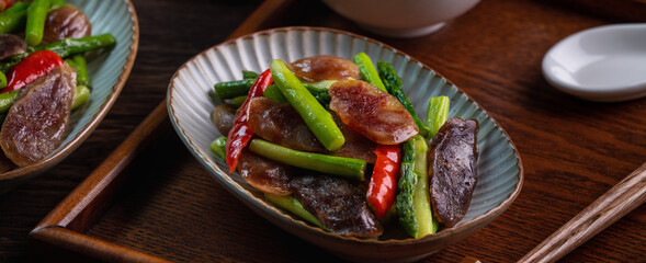 Delicious spicy homemade stir-fried Chinese smoked sausage with asparagus.