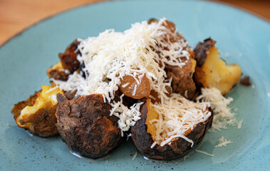 Baked potatoes with feta cheese. Close view.
