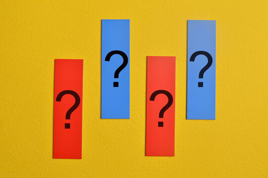 Questions marks drawn on memo notes isolated on yellow background