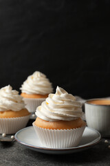 Delicious cupcakes with cream on grey table. Space for text