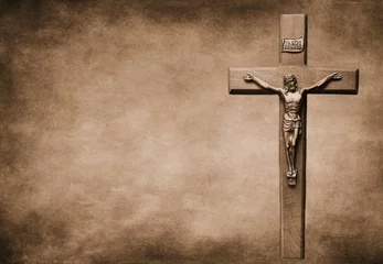 Foto op Plexiglas Closeup shot of a Sepia-toned crucifix with the body of Christ on a large background © Diane Kuhl/Wirestock