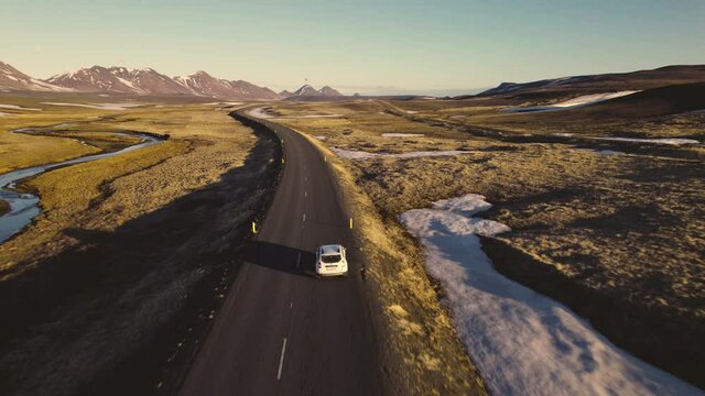 Majestic Drone Shot of Endless Green Fields and Snowcapped Mountain Landscape