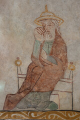 ancient Wall-painting of Saint Joseph, the husband of Mary, in a jewish hat, sitting in a chair