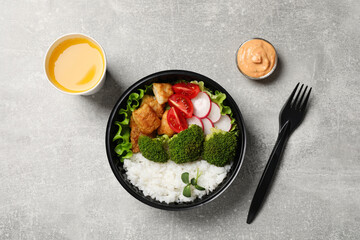 Healthy takeaway meal served with sauce and juice on light grey table, flat lay
