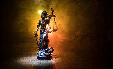 Obraz na płótnie Canvas Law concept. Miniature colorful artwork decoration with fog and backlight. The Statue of Justice - lady justice or Iustitia Justitia the Roman goddess of Justice. Selective focus