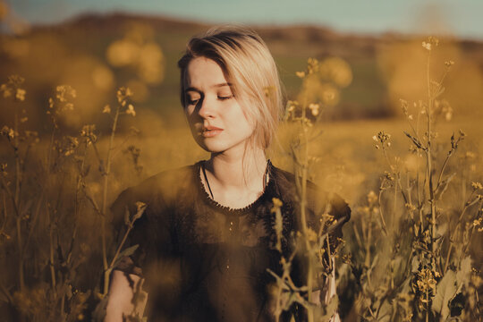 young dreamy woman in countryside