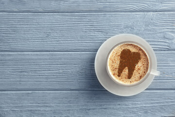 Coffee causing dental problem. Cup of hot drink on wooden background, top view