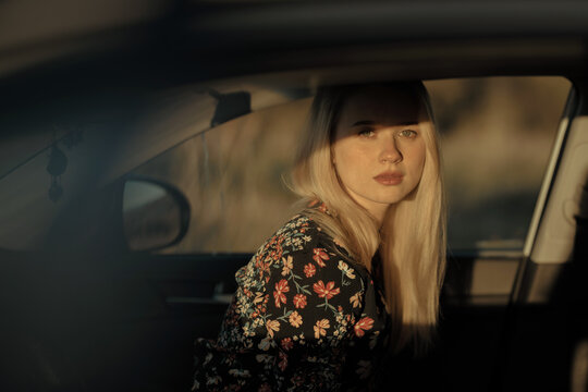 Beautiful blonde woman inside a car