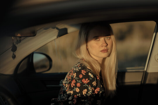 Beautiful blonde woman inside a car