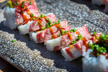 salmon sushi with cream and spices on a plate