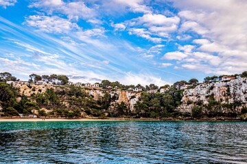Naklejka na ściany i meble beautiful beach in menorca with blue sky and white clouds