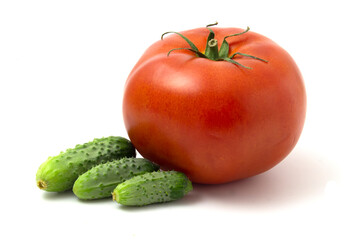 Fresh gherkins and big red tomato isolated on white background.