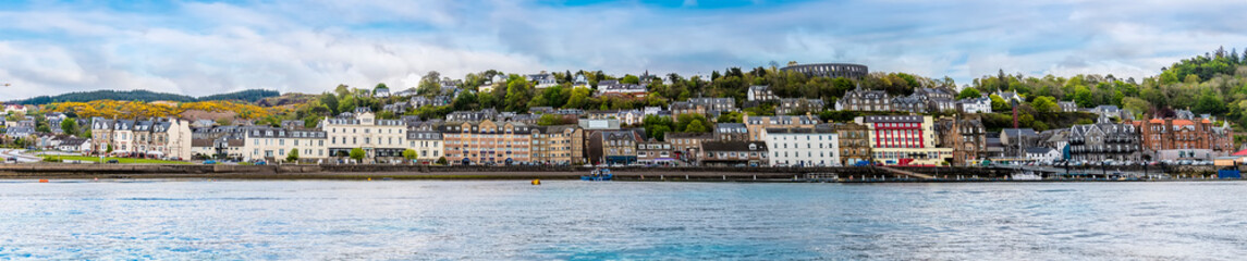 Obraz premium A panorama view of seafront of the town of Oban, Scotland from Oban Bay on a summers day